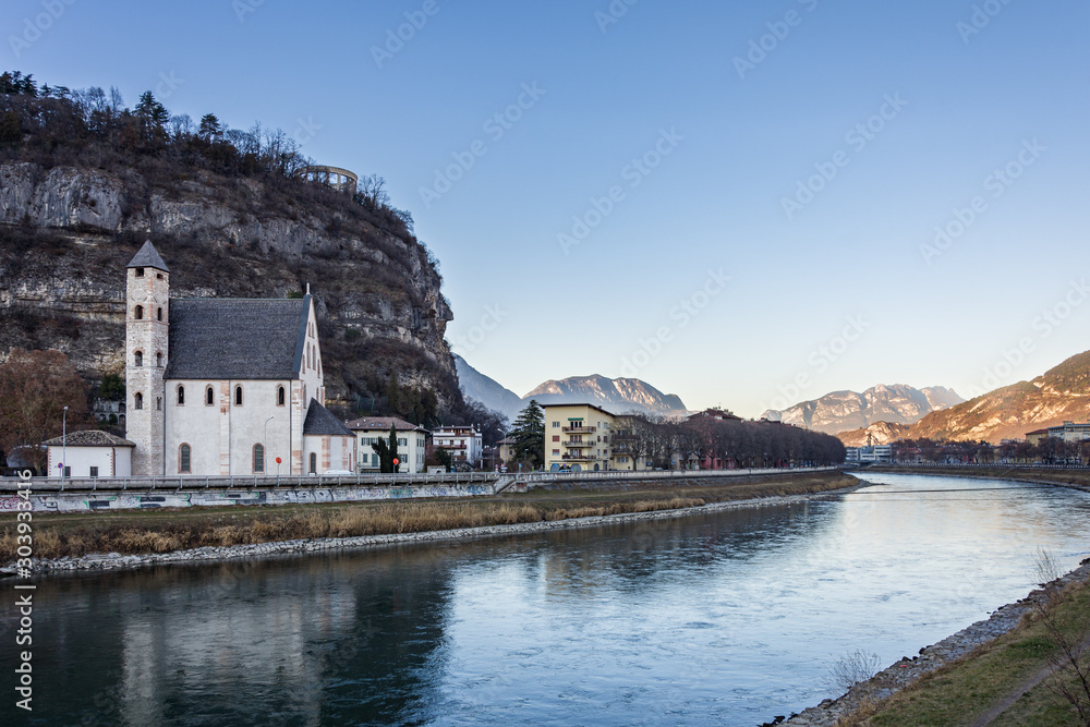 Beautiful scenery of Trento city with Saint Apollinare church at Adige river