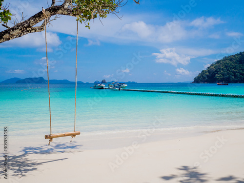 Rope and bamboo swing with white sand beach sea view background, Travel plans in holidays or after retirement