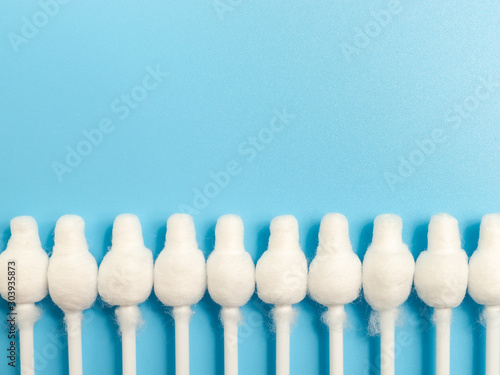 cotton buds close-up on a light blue background, for children, hygiene and ear cleaning, cotton swab