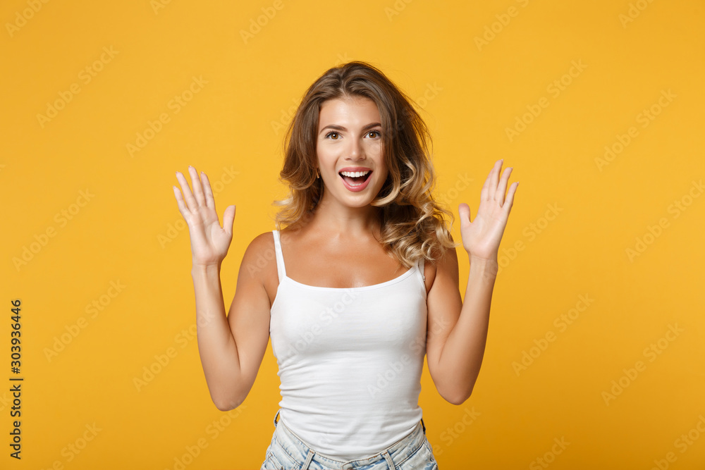Excited young woman girl in light casual clothes posing isolated on yellow orange wall background, studio portrait. People lifestyle concept. Mock up copy space. Keeping mouth open, spreading hands. Excited young woman girl in light casual clothes posing isolated on yellow orange wall background, studio portrait. People lifestyle concept. Mock up copy space. Keeping mouth open, spreading hands.