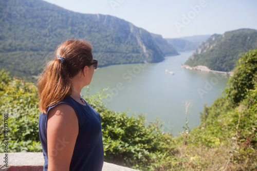 Woman enjoys the view on the Danube river photo