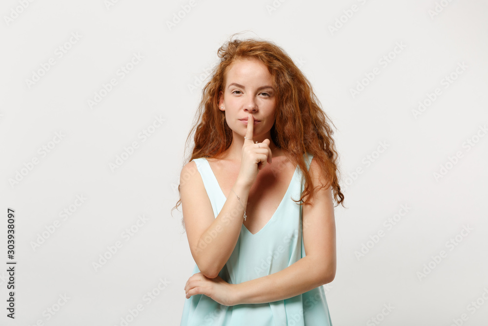 Young secret redhead woman girl in casual light clothes posing isolated on white wall background. People lifestyle concept. Mock up copy space. Saying hush be quiet with finger on lips shhh gesture. Young secret redhead woman girl in casual light clothes posing isolated on white wall background. People lifestyle concept. Mock up copy space. Saying hush be quiet with finger on lips shhh gesture.