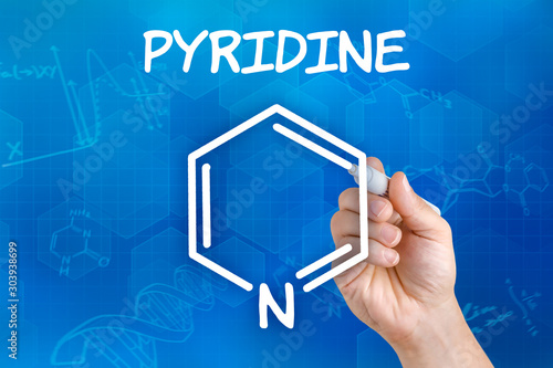 Hand with pen drawing the chemical formula of pyridine photo