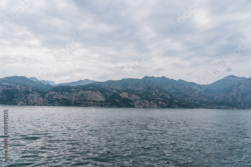Mountain ridge in clouddy days by lake garda in Veneto, Italy photo