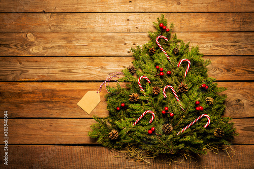 Christmas tree with decorations on wooden background