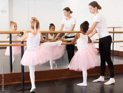 Girls practicing elements on ballet barre