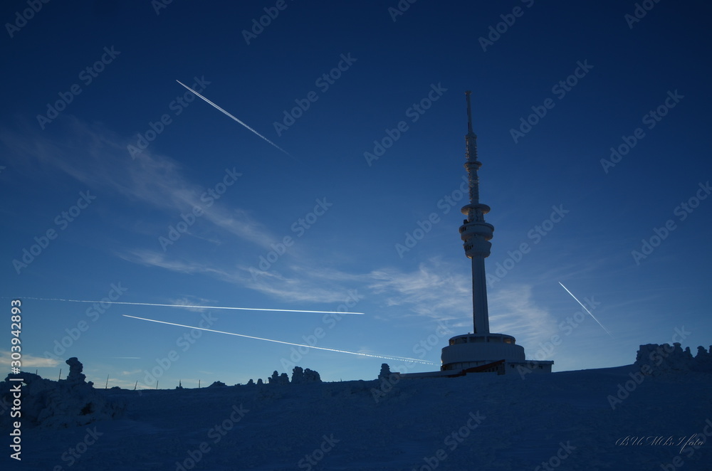 Antenna tower silhouette with blue sky