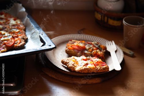 homemade pizza on a baking sheet, disposable tableware, concept zero plastic