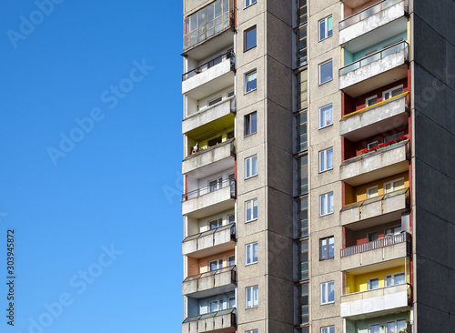 Old residential building against the blue sky, space for text.