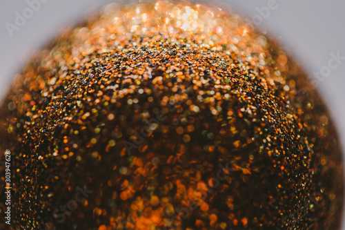 Abstract background of glitter globe with bokeh. Macro shot with shallow focus of a Christmas globe.