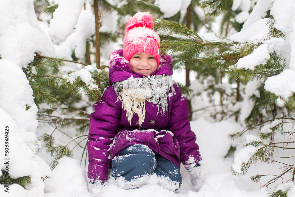 Happy mother holding her daughter above her head and having fun in winter snowy forest Happy mother holding her daughter above her head and having fun in winter snowy forest
