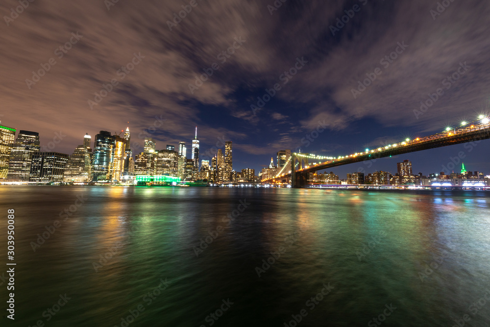 Manhattan skyline and Brooklyn Bridge by night