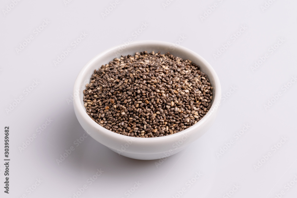 Chia seeds isolated on white background, angle view, copy space, studio shot, soft light. Latin name (Salvia hispanica). Chia seeds isolated on white background, angle view, copy space, studio shot, soft light. Latin name (Salvia hispanica).