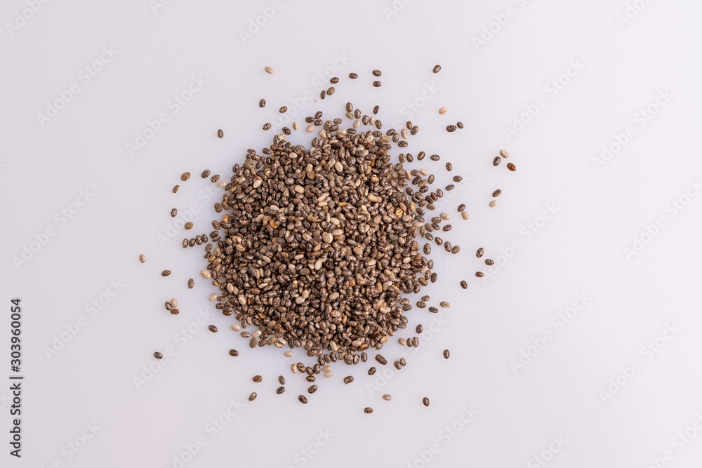 Chia seeds isolated on white background, angle view, copy space, studio shot, soft light. Latin name (Salvia hispanica). Chia seeds isolated on white background, angle view, copy space, studio shot, soft light. Latin name (Salvia hispanica).