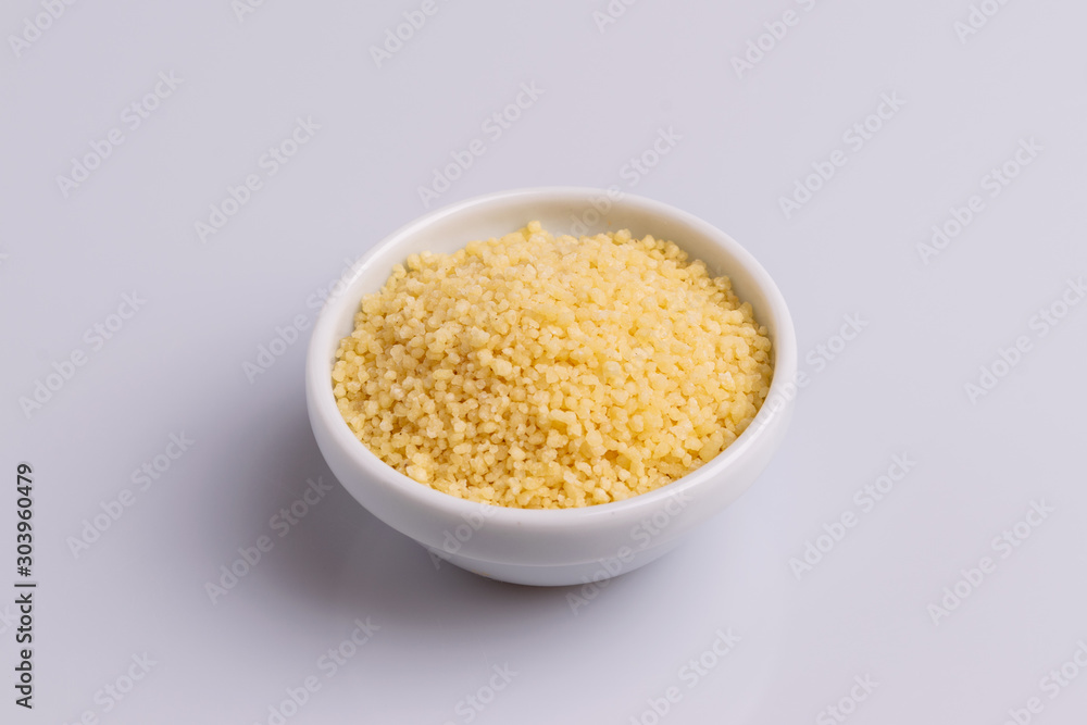 Dry couscous isolated on white background, soft light, copy space. Dry couscous isolated on white background, soft light, copy space.