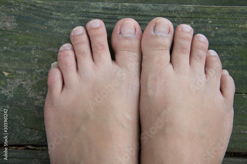 woman feet on wooden deck © oathka