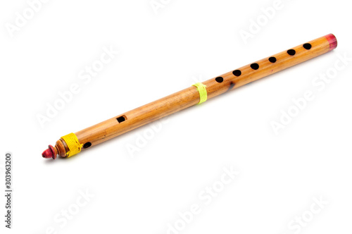 Bamboo wind instrument indian flute on white background photo