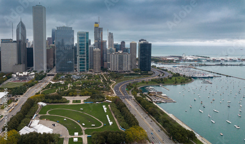 View of Downtown Chicago buildings looking north over Grant Park with Lake Michigan and Lake Shore Drive on right side. Prudential Building and Standard Oil Buildings on left side. photo