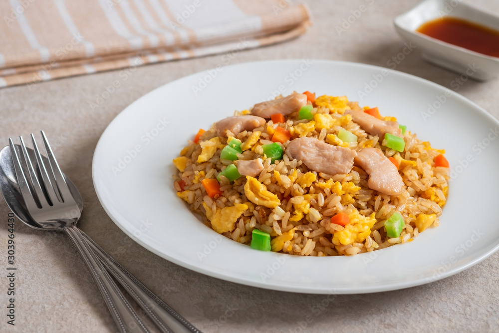 Fried rice chicken with egg and vegetables on white plate. Fried rice chicken with egg and vegetables on white plate.