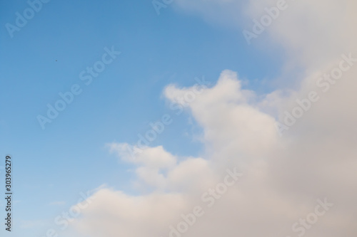 White fluffy clouds on a blue sky.