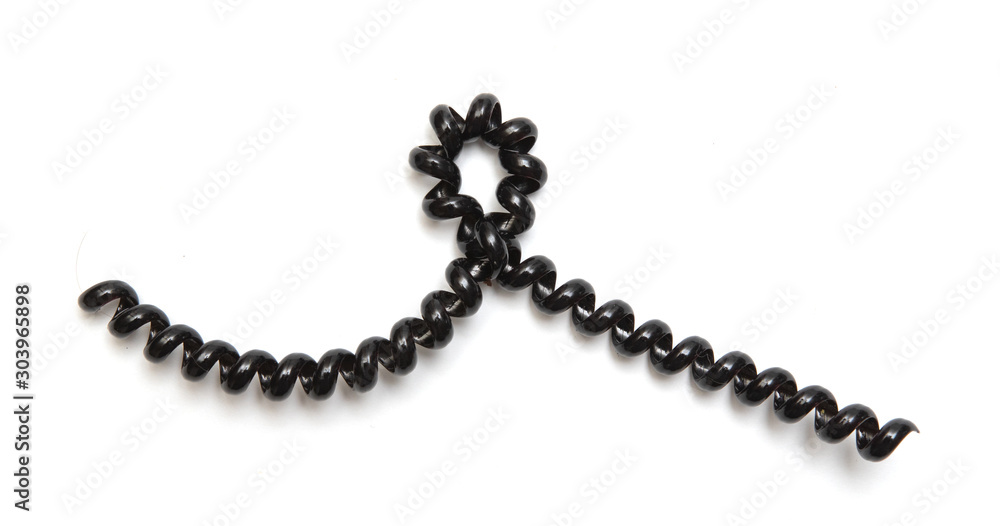 Black curly cord wire, on a white background. Black curly cord wire, on a white background.