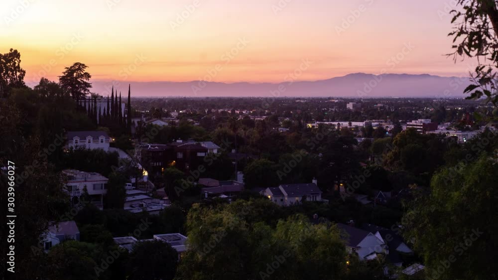 Timelapse of sunsetting on valley neighborhood as smoke blows across the town Timelapse of sunsetting on valley neighborhood as smoke blows across the town