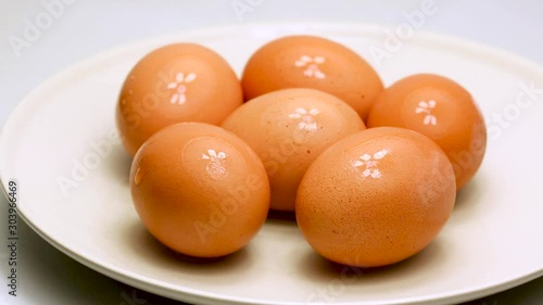 Boiled chicken eggs on a plate, rotation