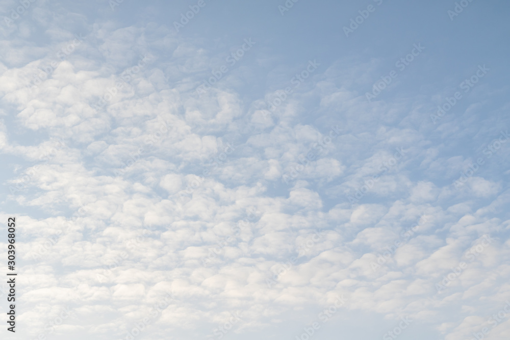 Blue sky background with little cloud cover. The texture of the blue sky.