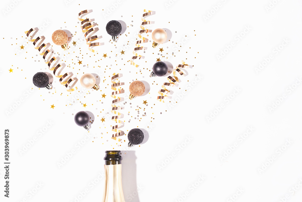 Christmas or New Year composition with champagne bottle and confetti. - obrazy, fototapety, plakaty 