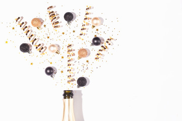Christmas or New Year composition with champagne bottle and confetti.