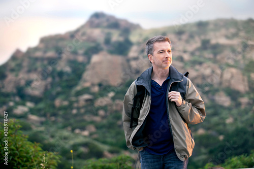 Fotografie Middle aged man staying healthy by doing outdoor activities during a nature getaway vacation