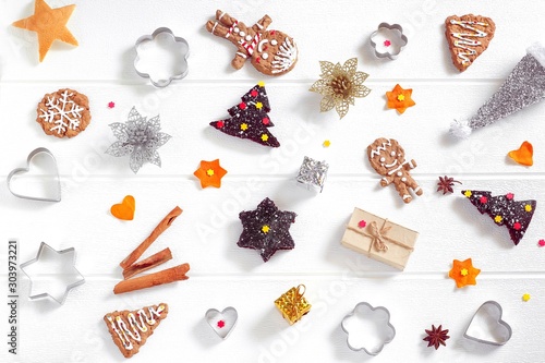 Christmas tree brownie cake with spices, homemade gingerbread cookies, cookie cutters, Happy New year dessert sweet treat for holiday party on white background, flat lay, top view, copy space