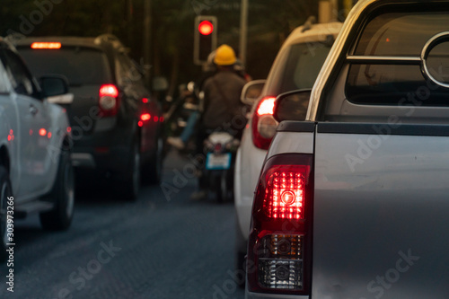 ฺBrake of pick up car on asphalt roads during rush hours for travel or business work. Evening environment. Traffic jam with other car and motorcycle blurred image. © thongchainak