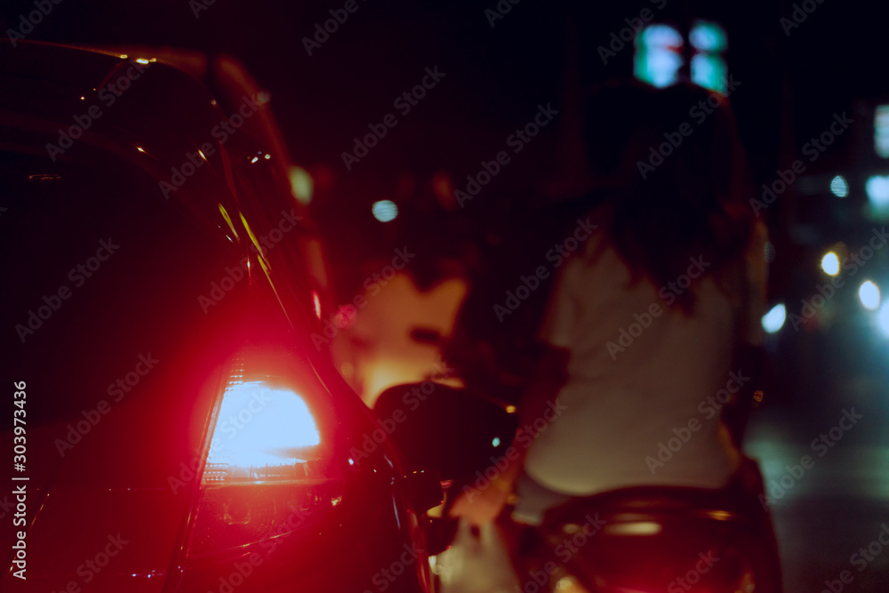 Blurred image of cars on the road with light break at in night. And motorcycle with people blurred image.