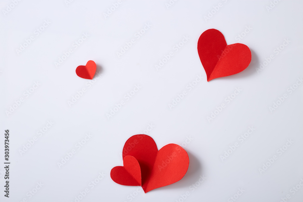 Fotografie Red paper hearts on white background