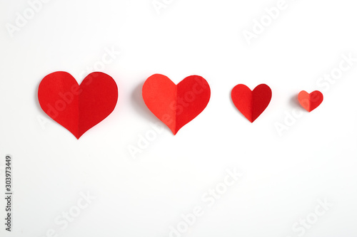 Red paper hearts on white background