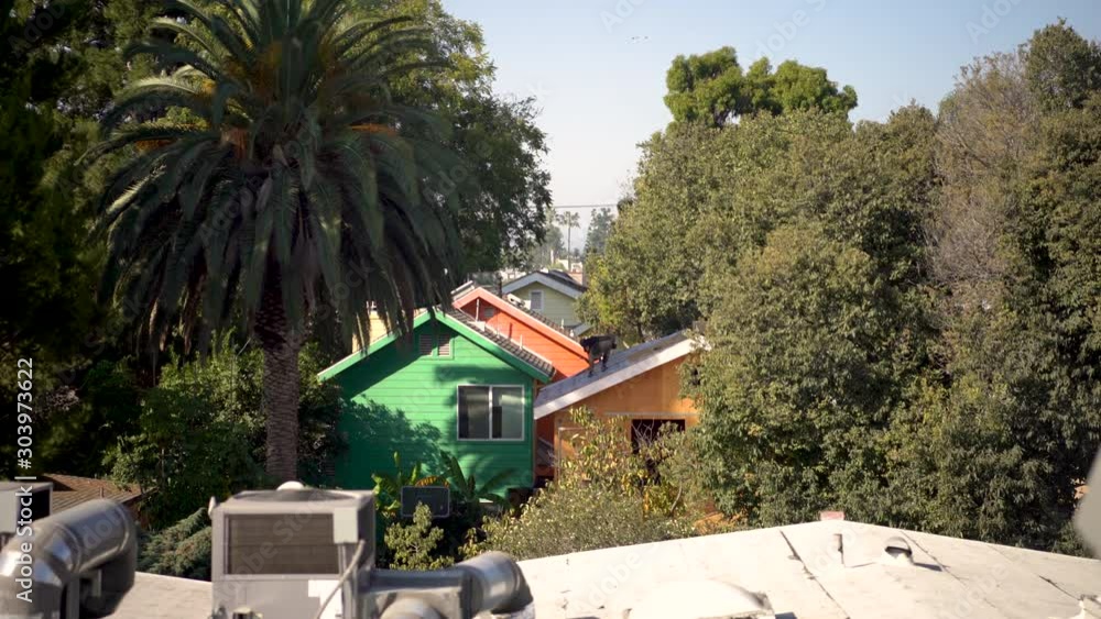 Roofer hammering nails and working on top of house. Roofer hammering nails and working on top of house.