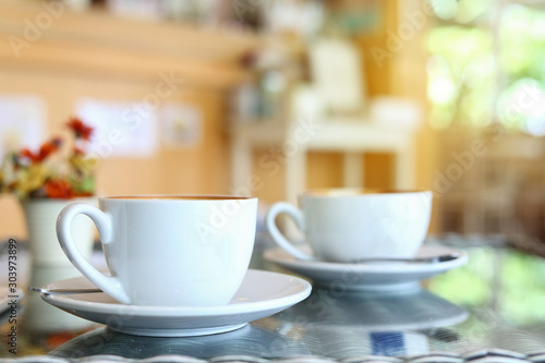 white cup of hot coffee drink put on table in cafe restaurant