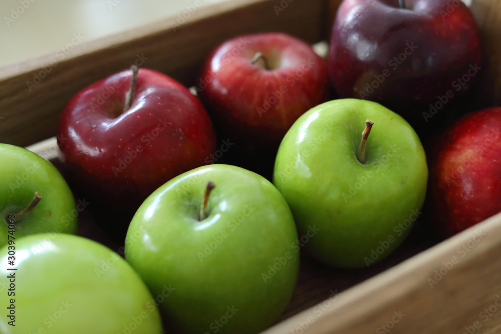 red and green apple fruit in harvest wood basket red and green apple fruit in harvest wood basket