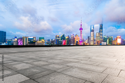 Empty square floor and modern cityscape in Shanghai at night.