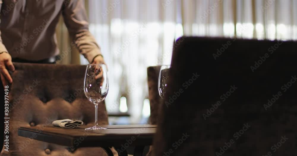 Brunette woman and bearded man are sitting down at the table in restaurant. Brunette woman and bearded man are sitting down at the table in restaurant.