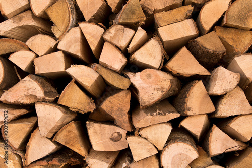 The background texture of a large pile of wood. Close up. Selective focus.