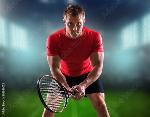 Young tennis man paling on stadium background © BillionPhotos.com