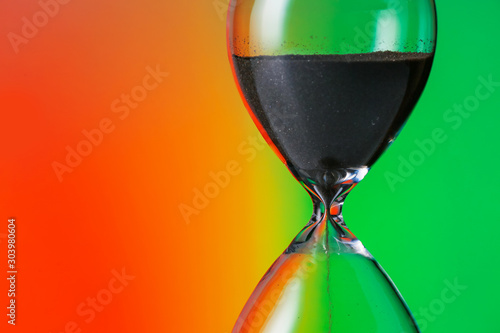 Crystal hourglass on color background