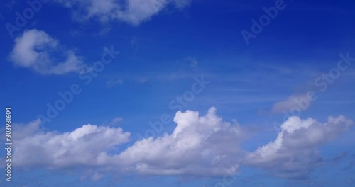 Bright blue sky of morning with white clouds moving slowly over Atlantic ocean, peaceful feelings, copy space