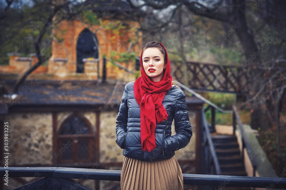 Outdoor portrait of a young woman in the autumn city