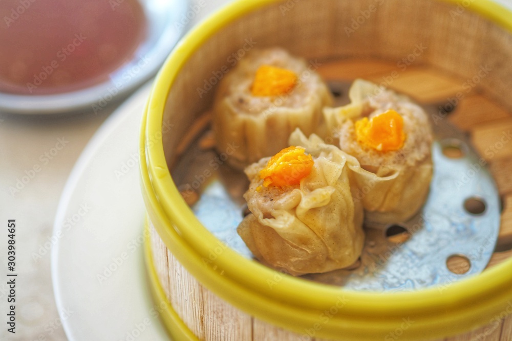 Crab Chinese steamed Dumpling with Salty Egg in bamboo steamer basket - Chinese food Dimsum menu Crab Chinese steamed Dumpling with Salty Egg in bamboo steamer basket - Chinese food Dimsum menu