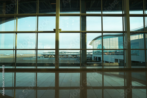 View of international airport runway and terminal from inside the gate