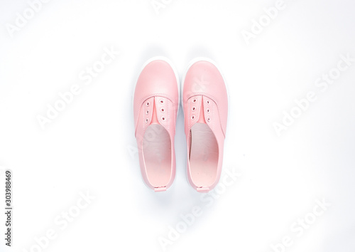 One pair of pink casual shoe for woman on isolated white background for poster, advertising or any issue about fashion.