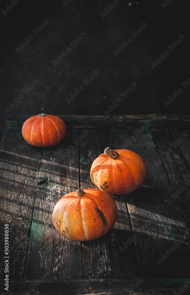pumpkins on old wooden table, natural light, copy space